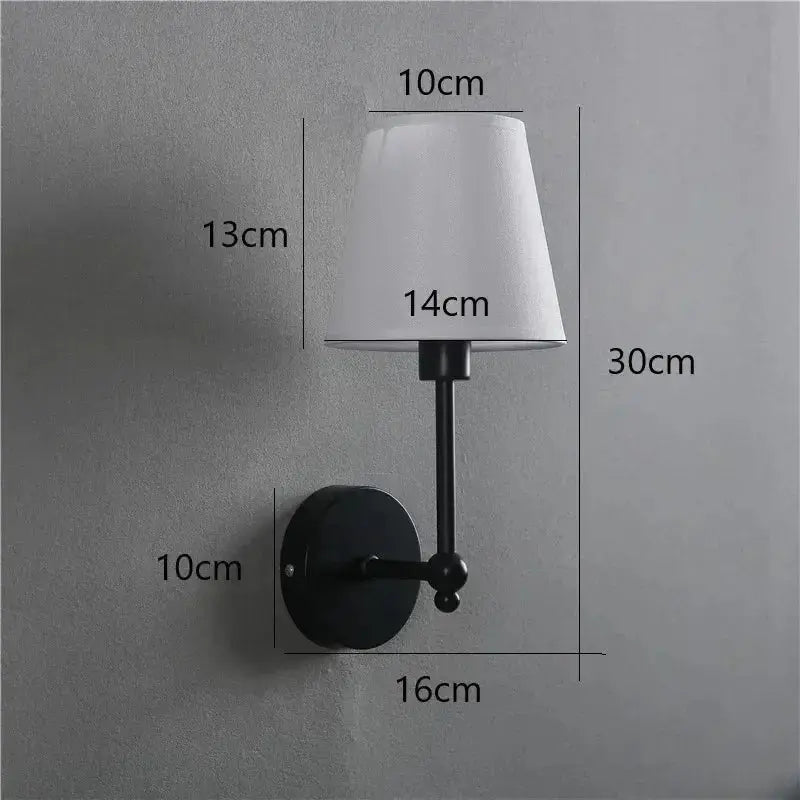 American Retro wall lamp by Simples Market with black metal arm and white fabric shade.