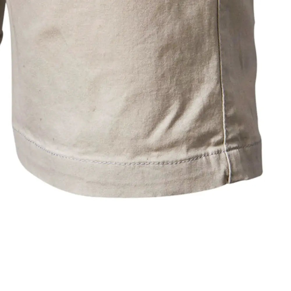 Shorts in beige 100% cotton with visible stitching and curved hem.