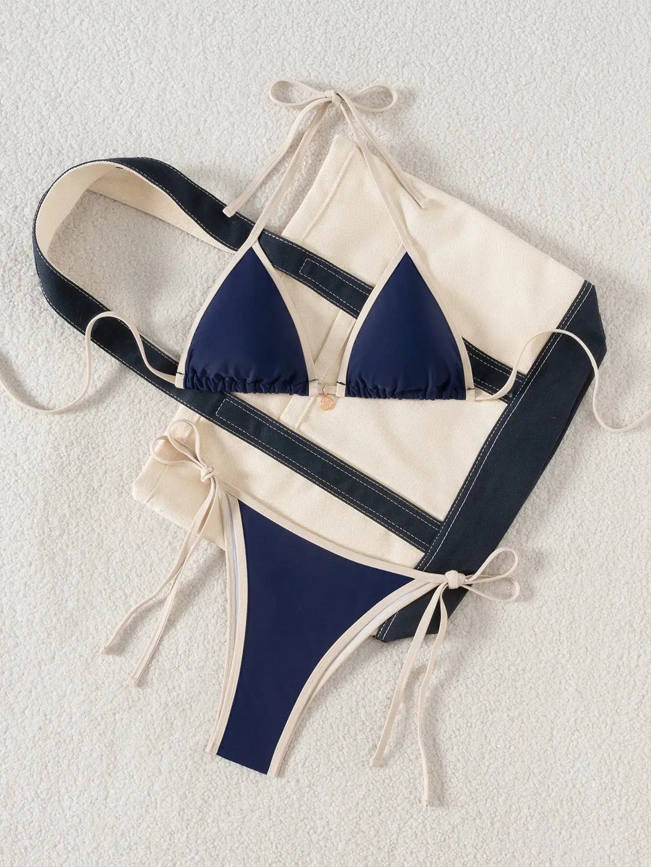 Simples Market two-piece triangle bikini set with navy cups and beige trim; Brazilian-cut bottoms.