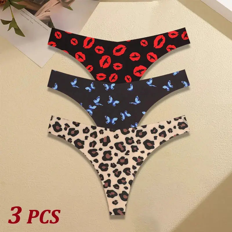 Three-piece women's seamless thong set by Simples Market in red lips on black, blue butterflies on navy, and leopard on cream