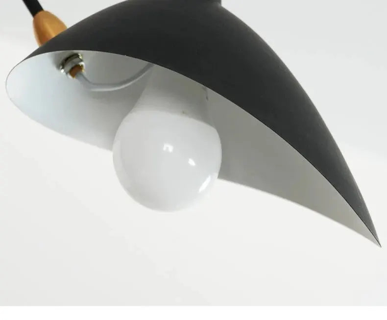 Spider grabbing pendant light, black curved shade with white bulb, by Simples Market.