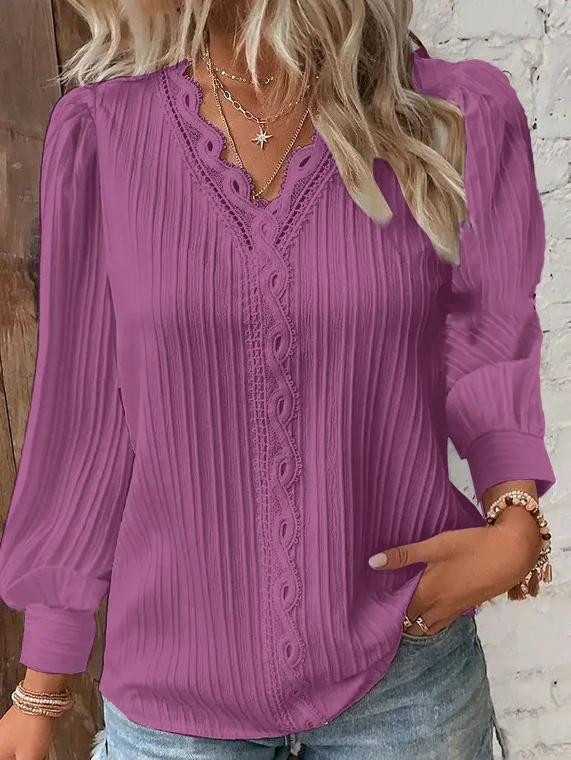Women's purple long-sleeve blouse with lace-trim V-neck and pleated fabric.