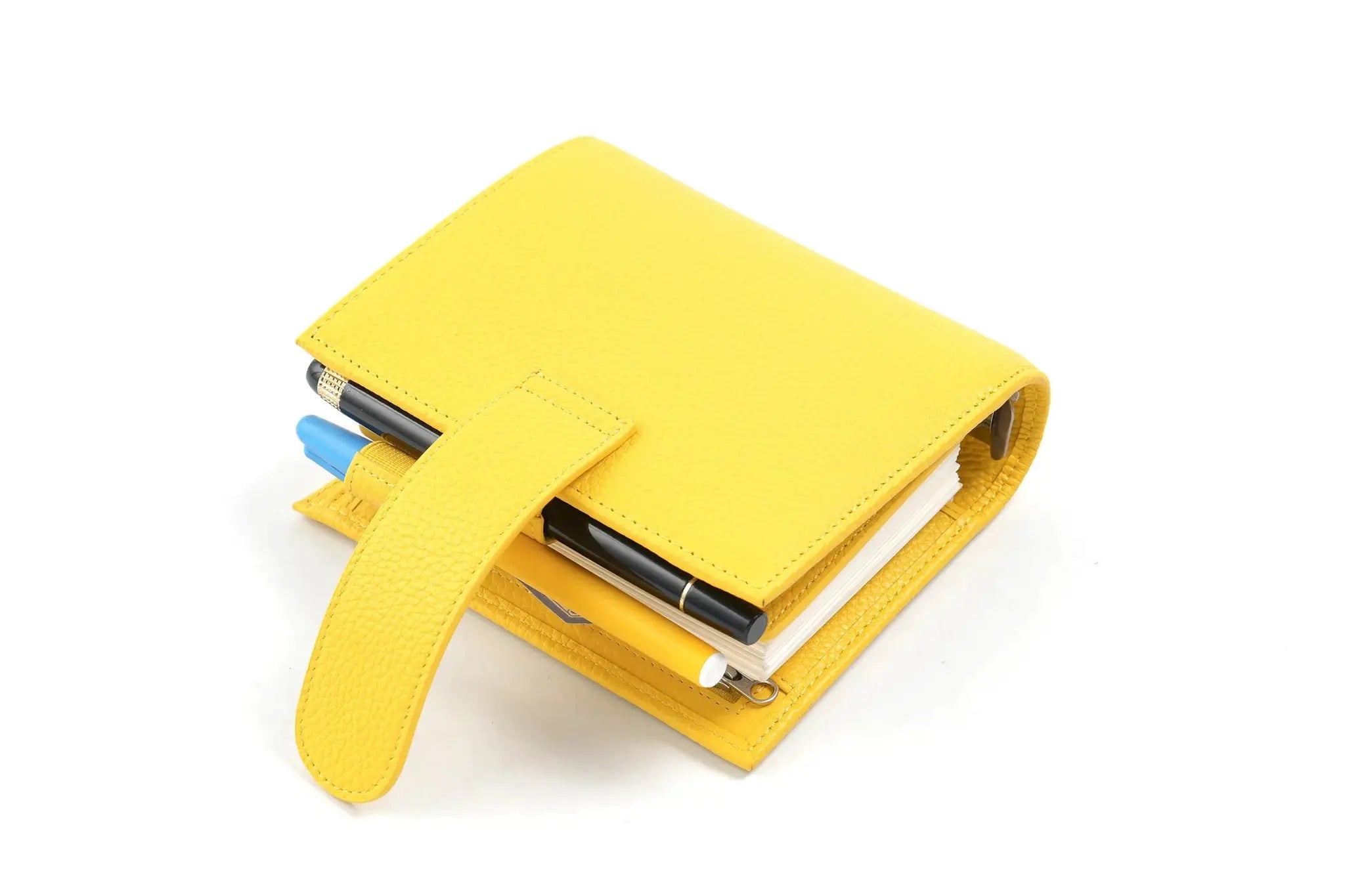 Moterm Luxe 2.0 pocket planner in yellow pebbled leather with three pens tucked in (blue, black, yellow).