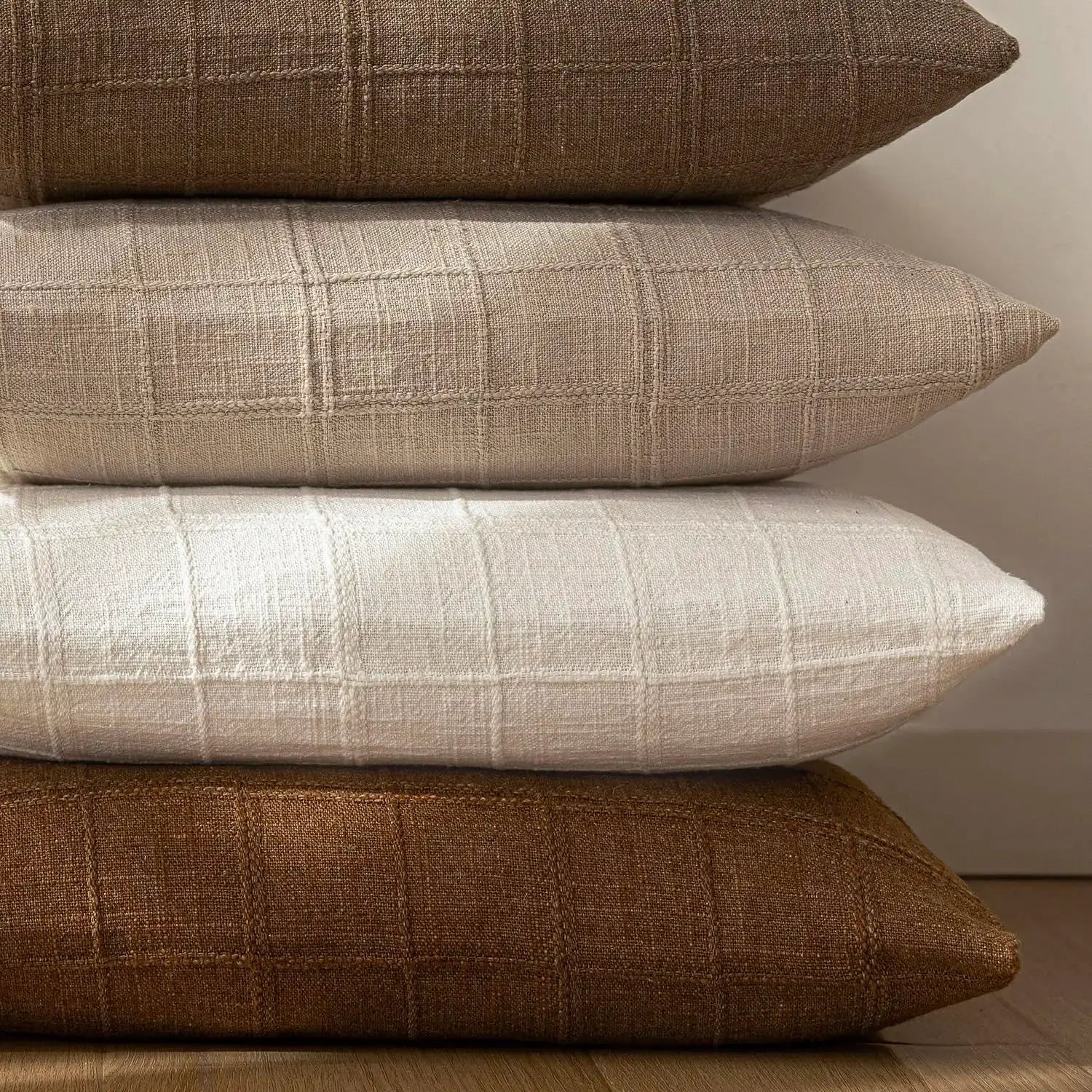 4 square linen cushion covers with a woven grid pattern in beige, white and brown tones