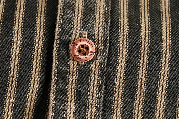 Men's striped long-sleeve shirt close-up with pink button on black-and-tan retro stripes
