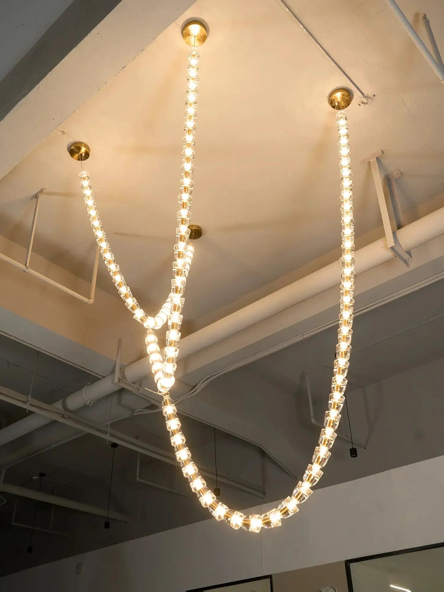 Necklace chandelier ceiling light by Simples Market; multi-strand crystal acrylic beads, warm white glow