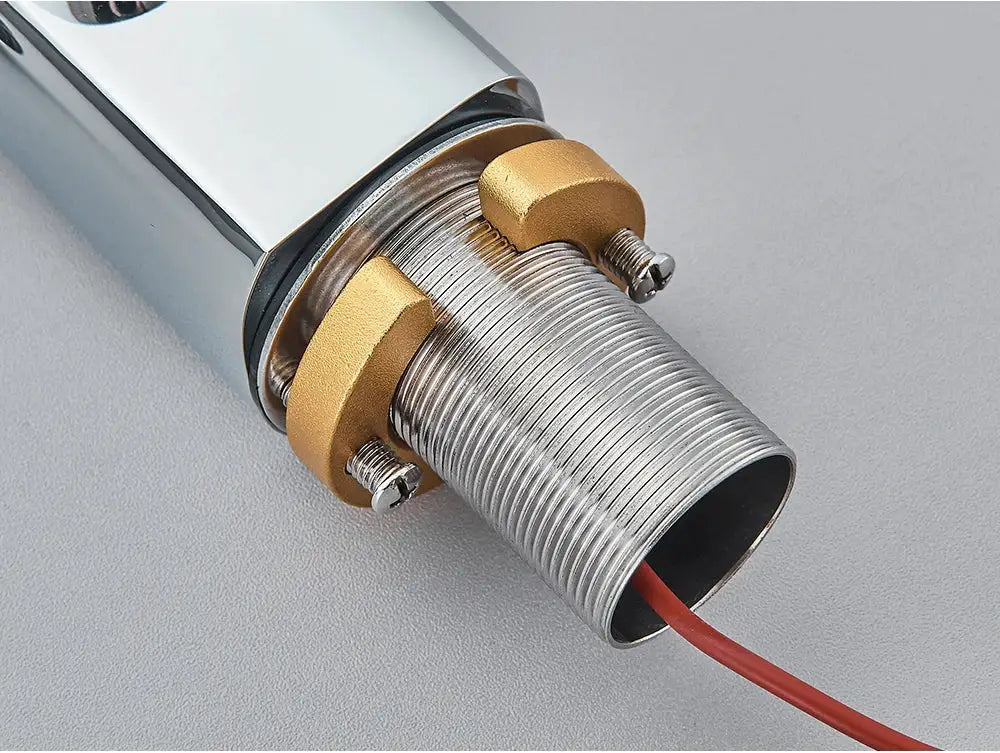 Smart sensor basin faucet component with chrome body, brass coupling nuts, threaded outlet, and red wiring