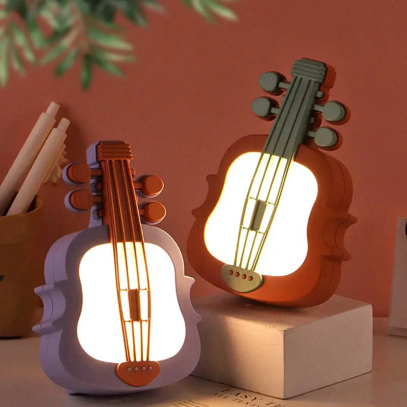 Guitar-shaped LED night lights pair in purple and orange by Simples Market for kids' room decor.