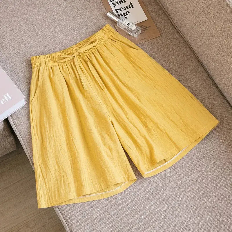 Women's yellow cotton shorts with drawstring waist, high-rise fit and two pockets