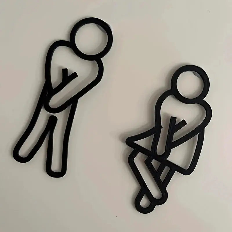 Two black 2D bathroom sign silhouettes for wall decor; playful restroom door signage set