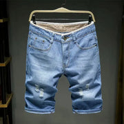 Men's light blue denim shorts with distressed knees; slim fit, belt loops