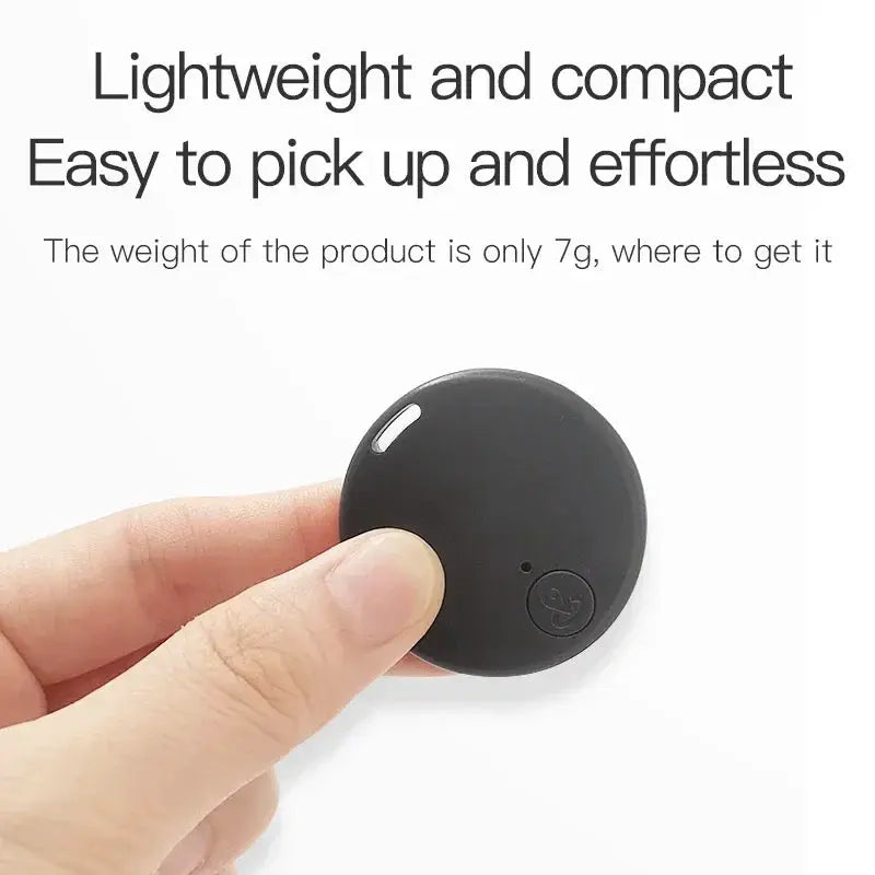 Xiaomi GPS tracker round black mini device held in hand, Bluetooth 5.0 anti-lost finder