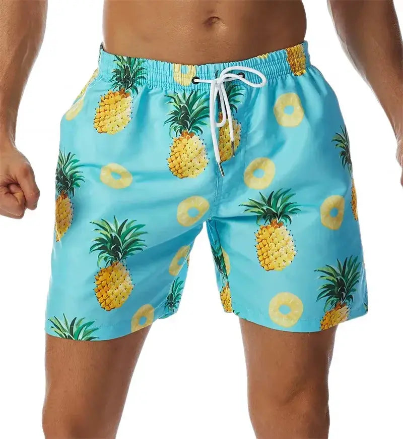 Board shorts by Simples Market; men's blue pineapple-print quick-dry shorts with white drawstring.