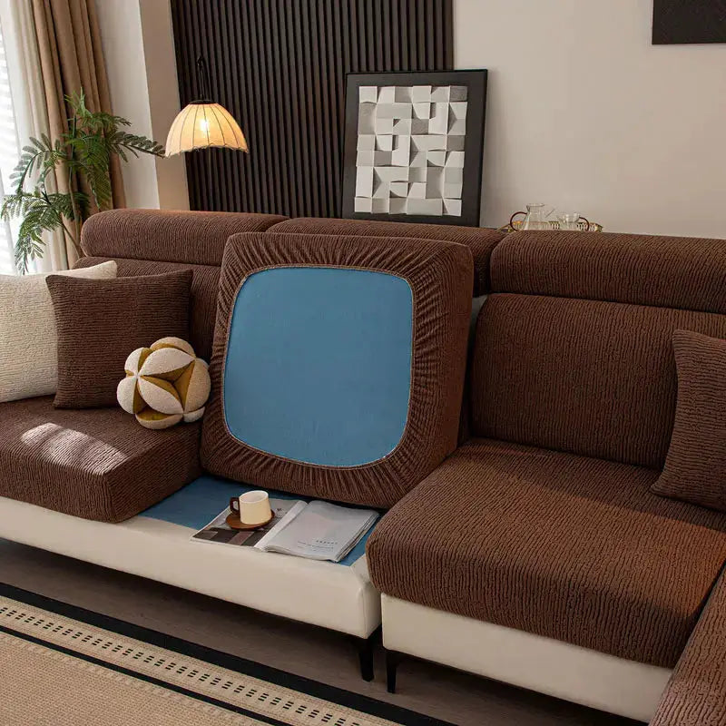Thick plush sofa cushion cover with blue insert on brown sectional; elastic edges, living room setup.