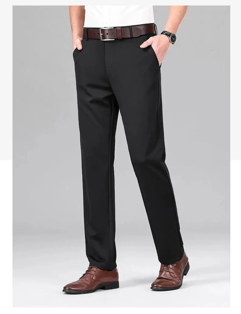 Men's black stretch dress pants for business use, shown with brown belt and dress shoes.