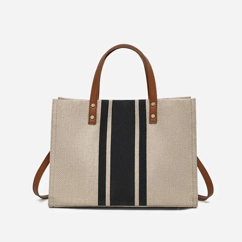 Simples Market canvas tote bag with beige body, black center stripe, and brown top handles