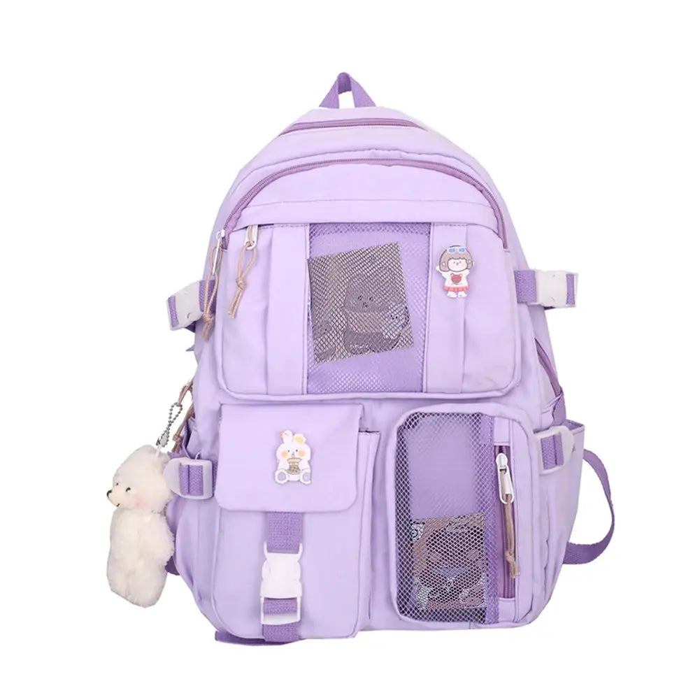 Purple school backpack with multiple pockets, mesh panels and a small plush keychain.