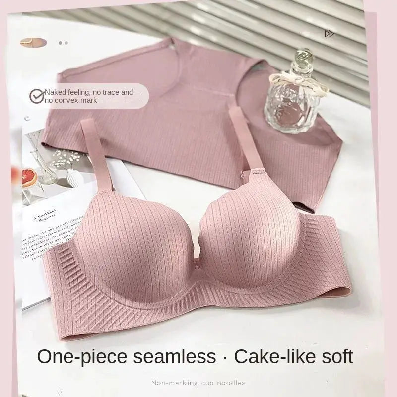 Two-piece pink push-up bra set with 6cm padded cups and ribbed seamless design, includes a matching pink top