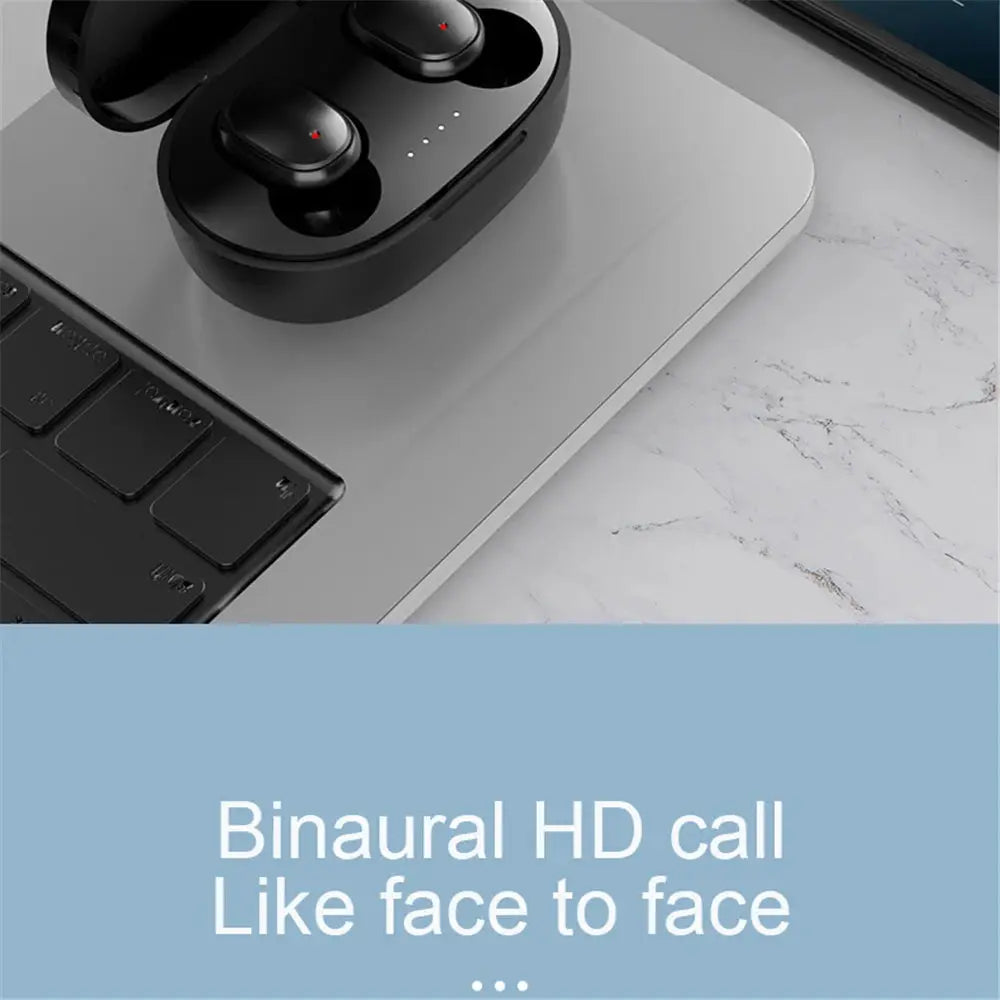 A6S wireless Bluetooth earphones in black charging case with LED indicators on a laptop surface