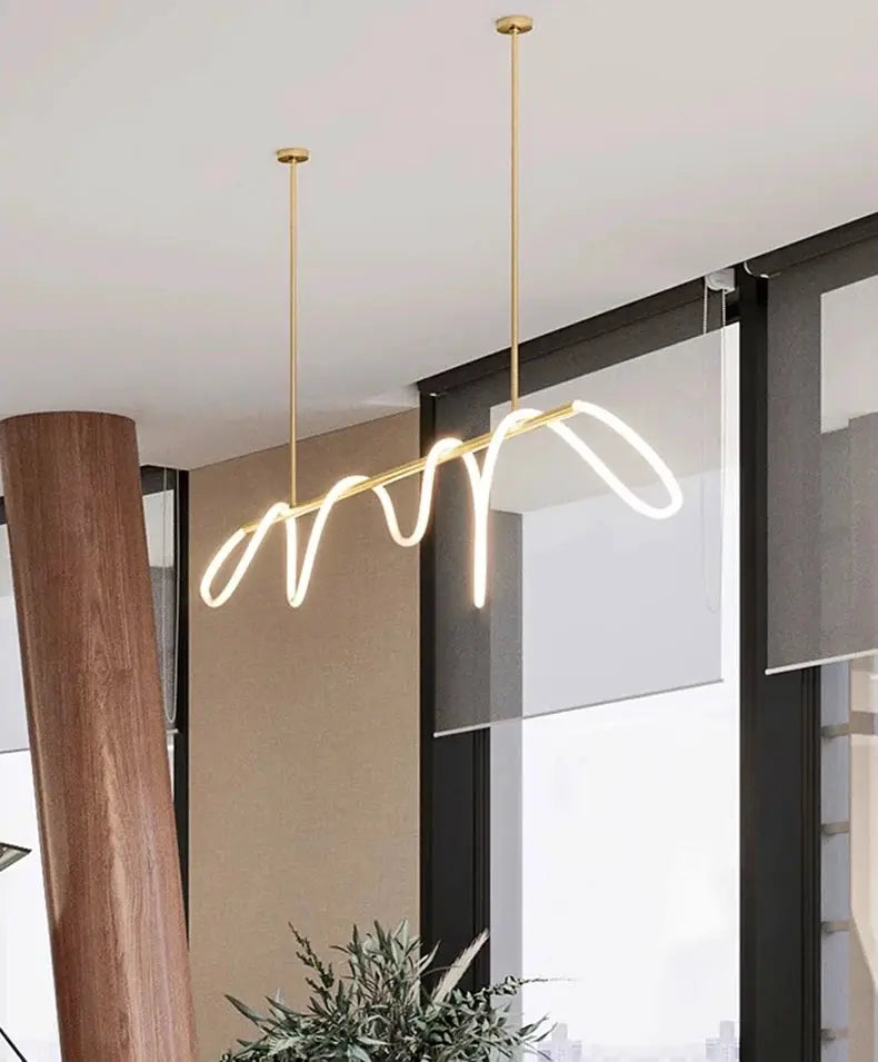 Nordic style pendant light with gold suspension and wave LED tube for dining room.