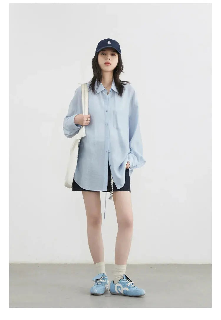 CHIC VEN women’s light blue loose long-sleeve button-front shirt with chest pocket, model with tote bag.