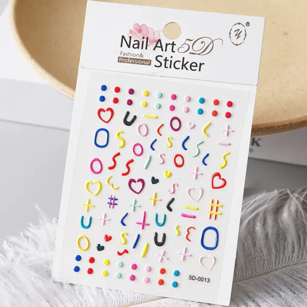 Nail art sticker sheet with assorted colorful 5D decals (hearts, letters, dots, symbols) by Simples Market