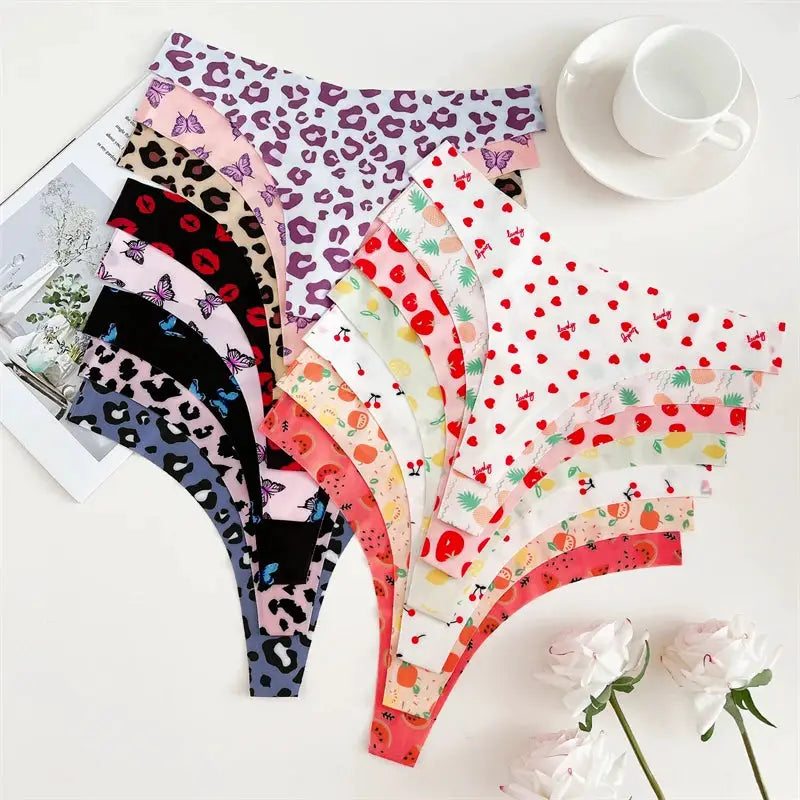 4-pack women's thong underwear set in assorted graphic prints, including leopard, fruit, and heart patterns