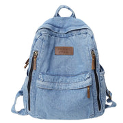 Denim backpack by Simples Market with multiple pockets, large capacity, light blue denim and brown leather zipper pulls