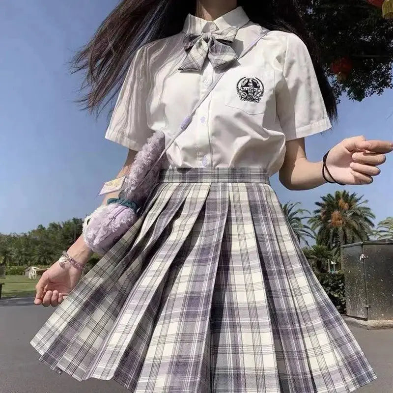 ZOKI plaid pleated high-waist skirt in gray and white plaid; paired with white blouse and bow