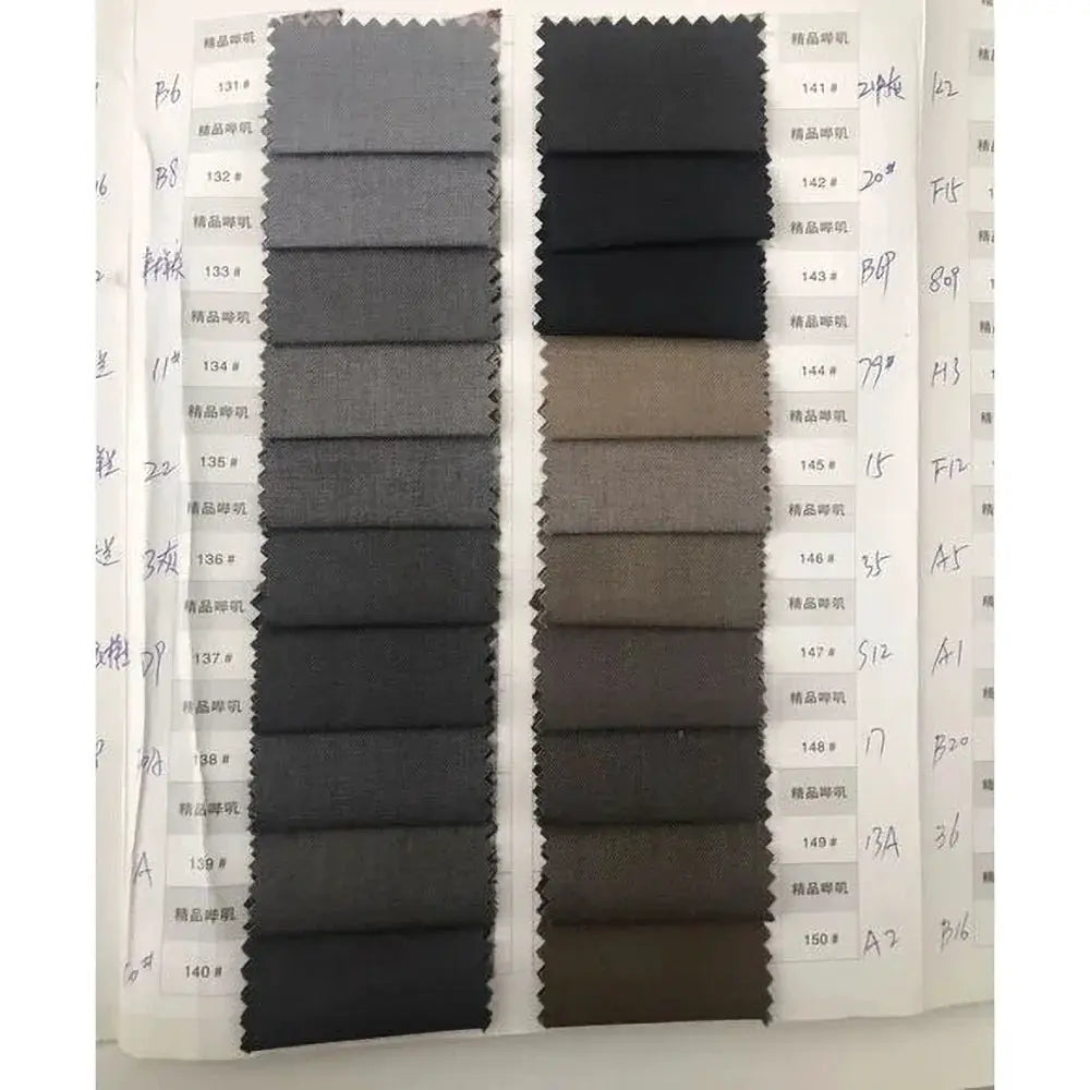 Fabric swatch book with gray to brown suit fabrics for women's blazer and pants sets; multiple swatches