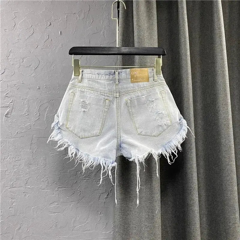Denim shorts for women with frayed uneven hem, light wash, back pockets, vintage streetwear style by Simples Market