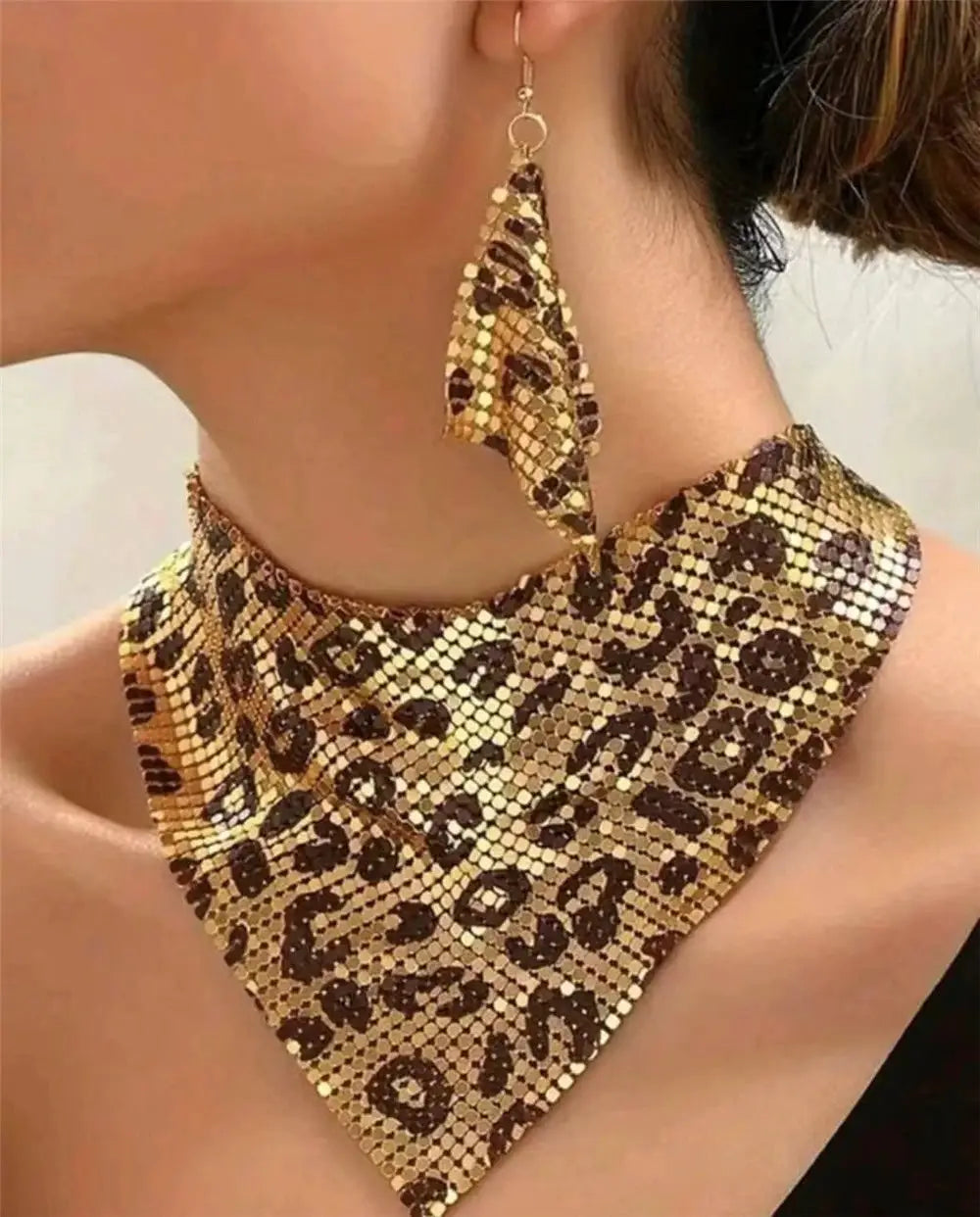 Leopard-print jewelry set with a gold-tone bib necklace and matching dangle earrings.