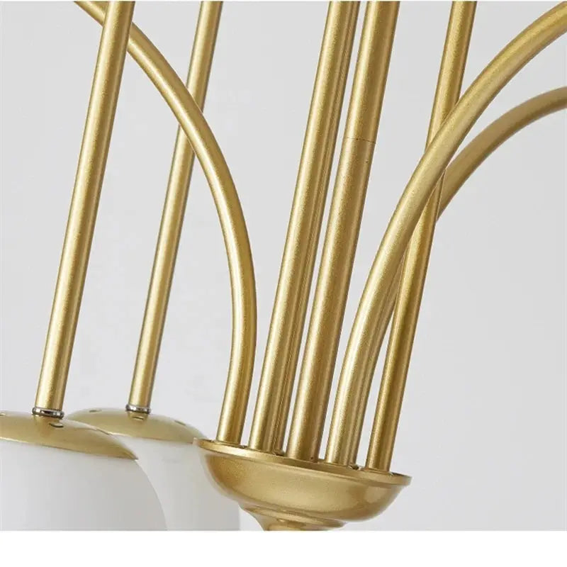 Nordic minimalist pendant light in gold with metal arms and white shade