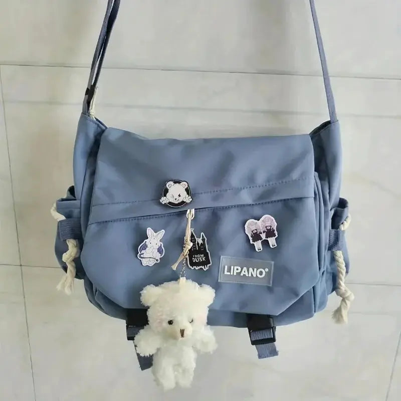 Men's blue nylon crossbody bag with large capacity, Lipano patches, and plush teddy charm.