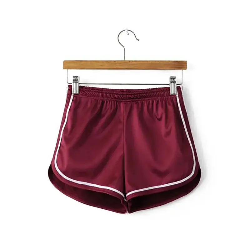 Women's burgundy silk shorts with white piping, elastic waistband, and curved hems for casual beachwear