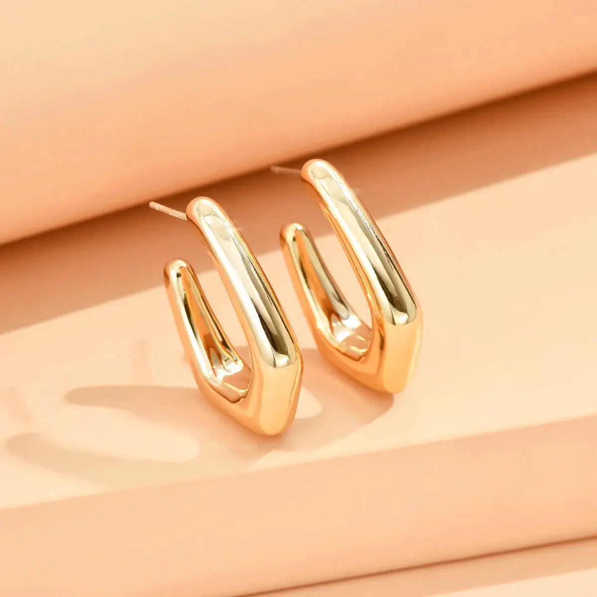 Pair of gold-tone geometric irregular stud earrings, minimalist metal jewelry for women