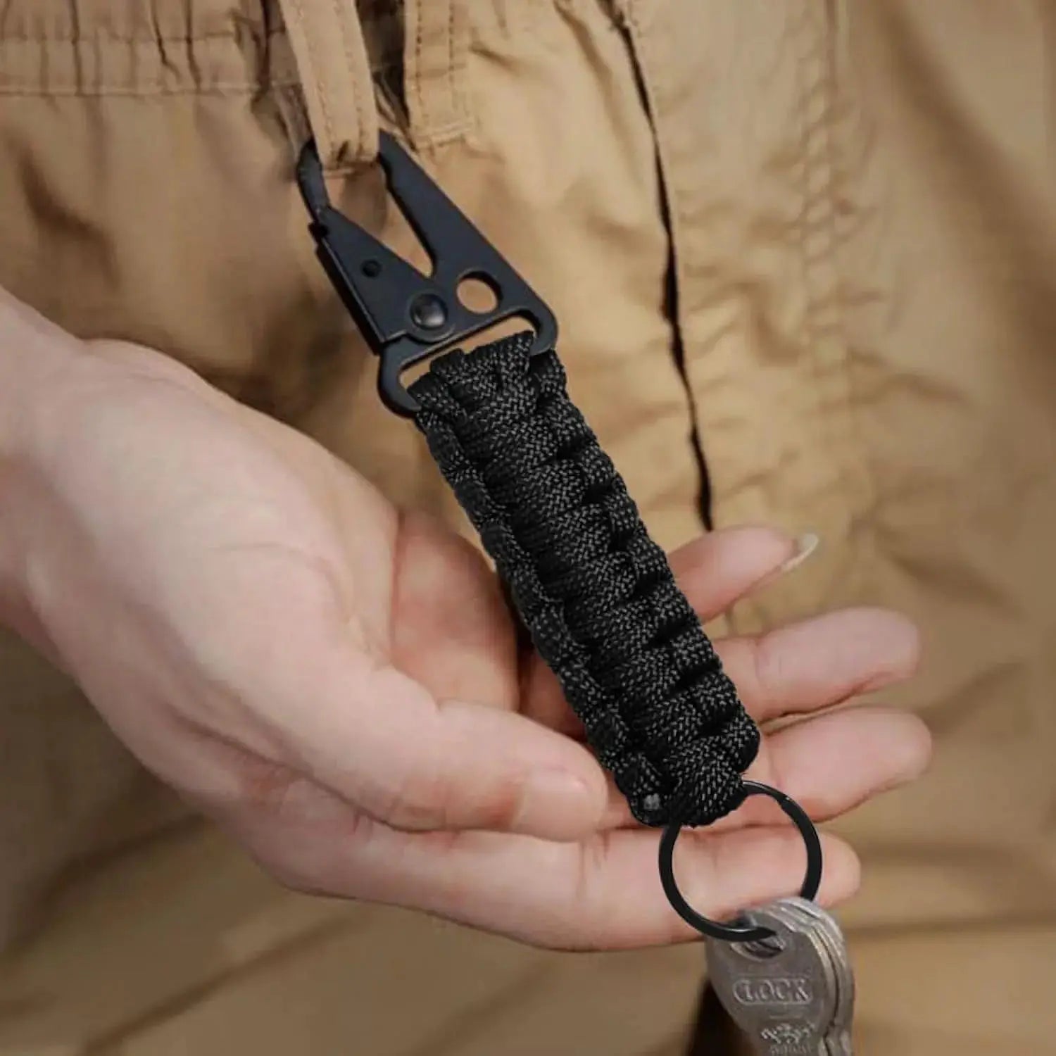 Paracord keychain with black braided cord and metal carabiner bottle opener by Simples Market