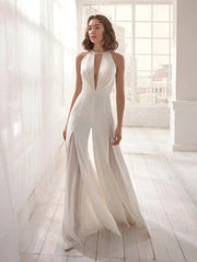White halter-neck jumpsuit with deep V neckline, sleeveless backless design and wide-leg flowing pants.