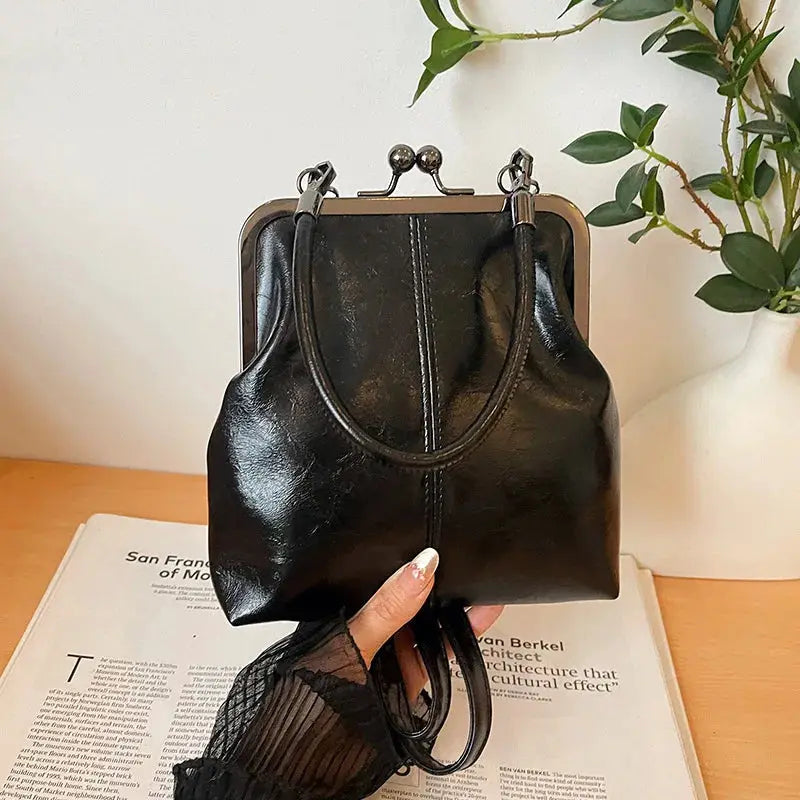 Black PU leather vintage-style women's handbag with metal-frame clasp and top handles