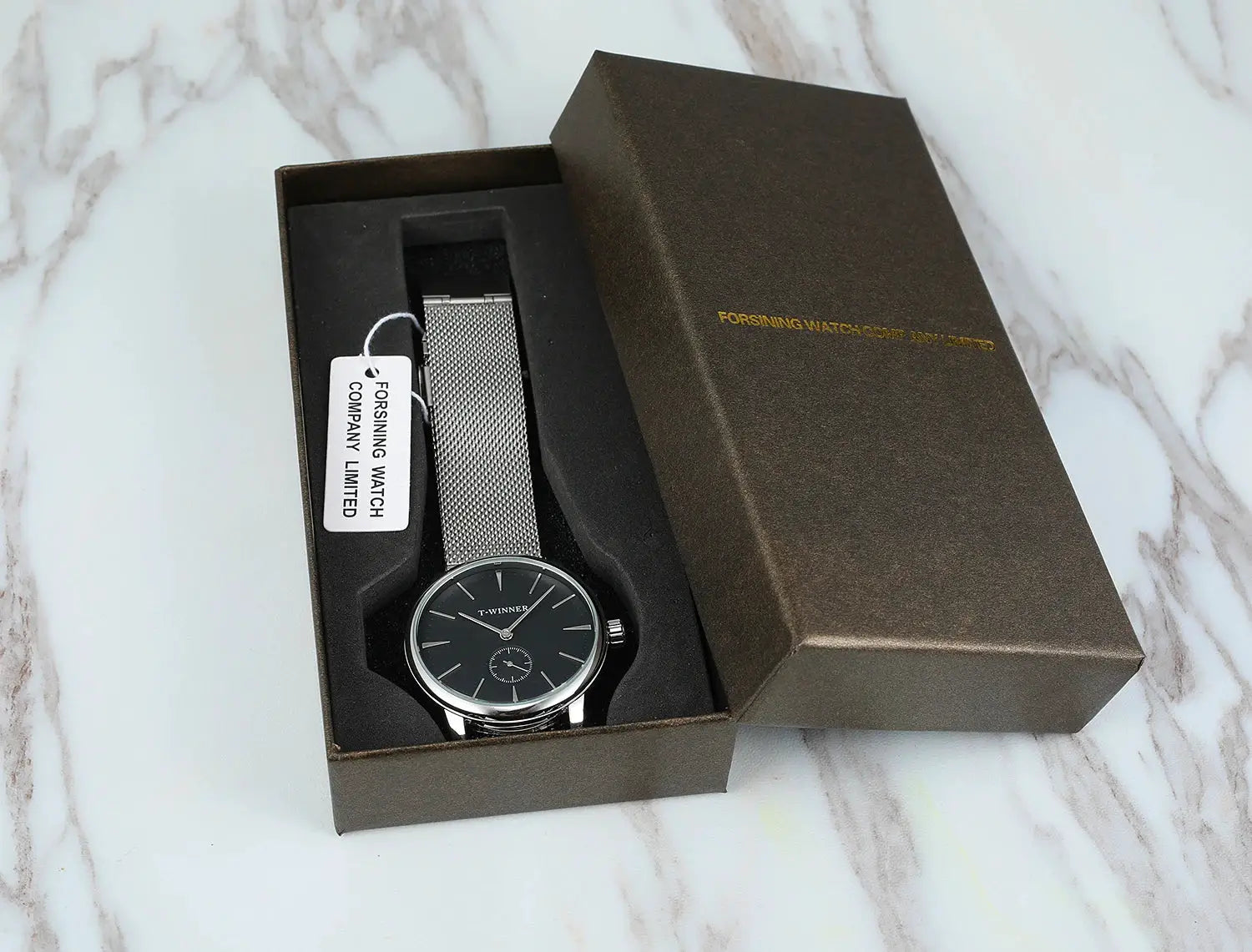 Winner wristwatch with silver stainless steel mesh strap and black dial in a presentation box