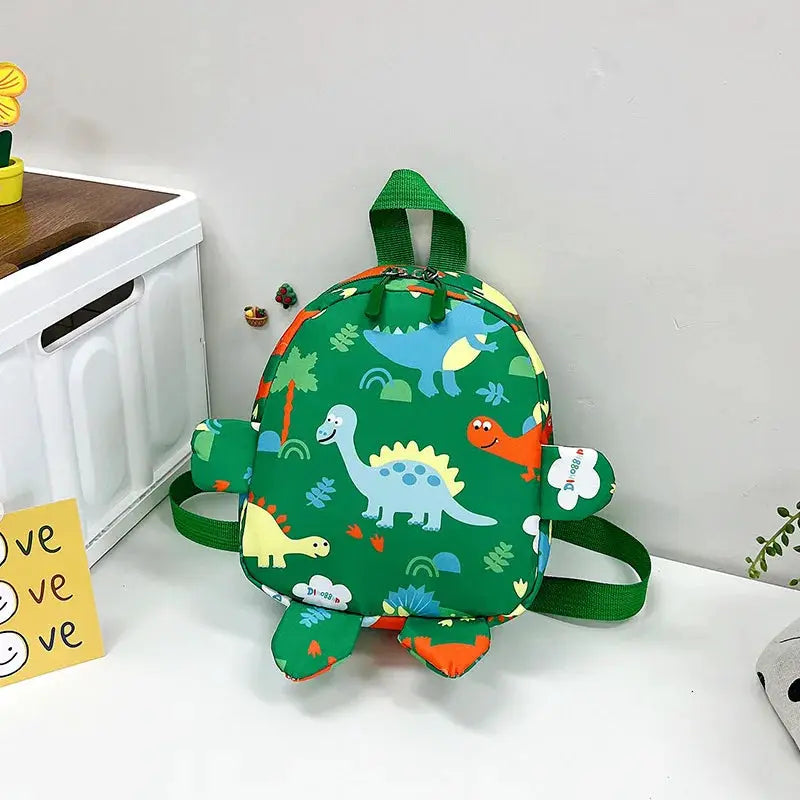 Dinosaur-shaped kids backpack, green with cartoon dinos print by Simples Market for preschool