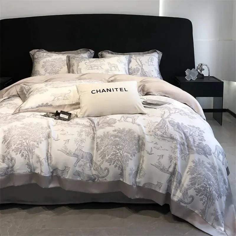Bedding set with cream and grey leopard-forest print duvet cover, sheets and pillowcases; CHANITEL pillow visible