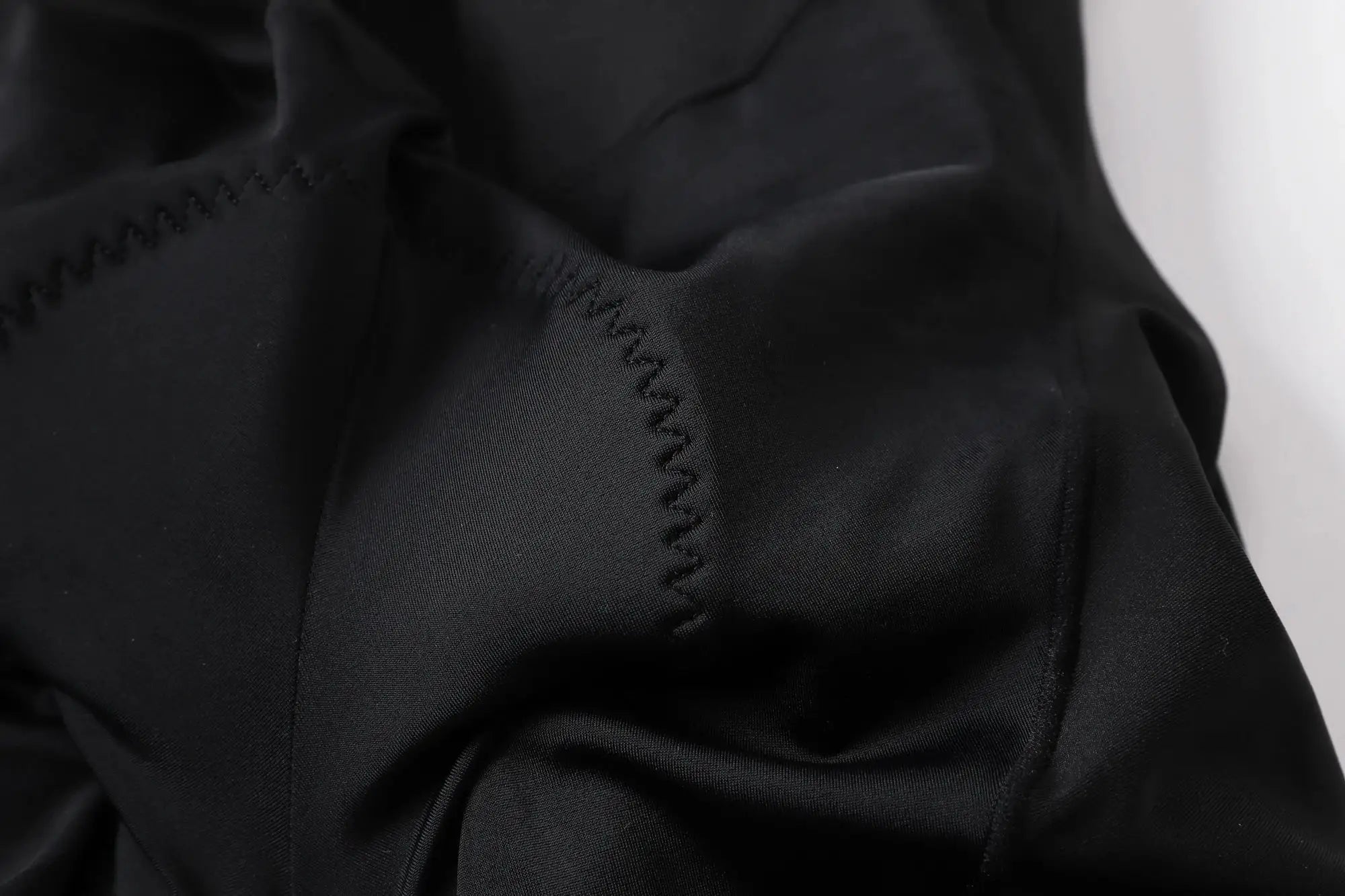 YKYWBIKE men's cycling bib shorts close-up of black fabric with visible stitching seam