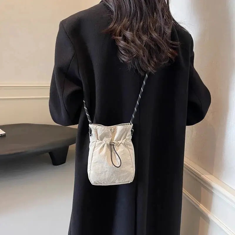 Nylon crossbody bag in beige, compact square purse with drawstring top and braided strap