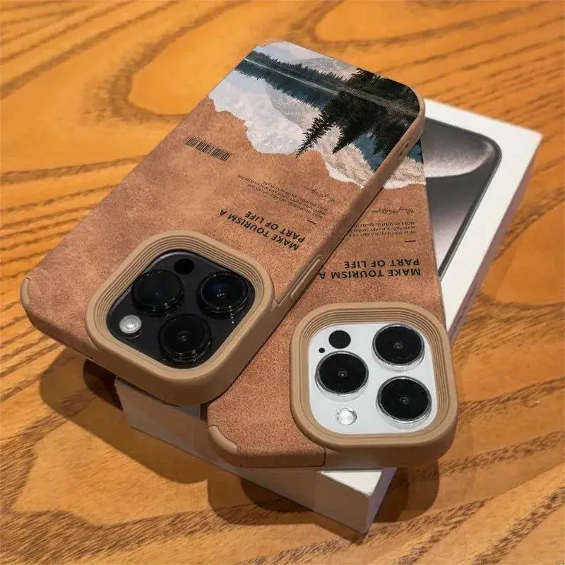 Pair of iPhone cases with mountain lake scenery, faux leather texture, tan borders — Simples Market