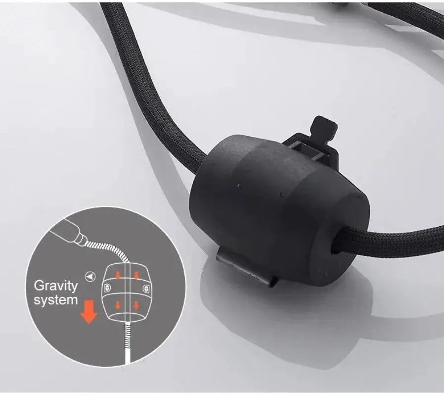 Pull-out kitchen faucet hose weight with gravity system, black cylindrical weight on braided hose.