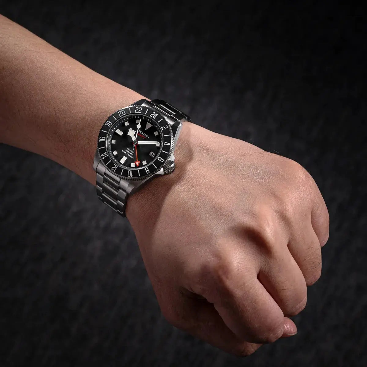 Seestern Diver Man Watch on wrist with black dial, stainless steel bracelet, GMT bezel.