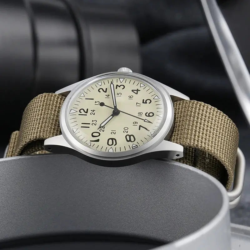 Militado ML07 quartz watch with beige dial, khaki canvas strap, silver case and luminous hands.