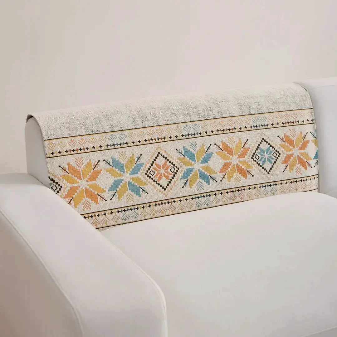 Bohemian jacquard chenille sofa cover on a white couch, cream base with multicolor geometric pattern