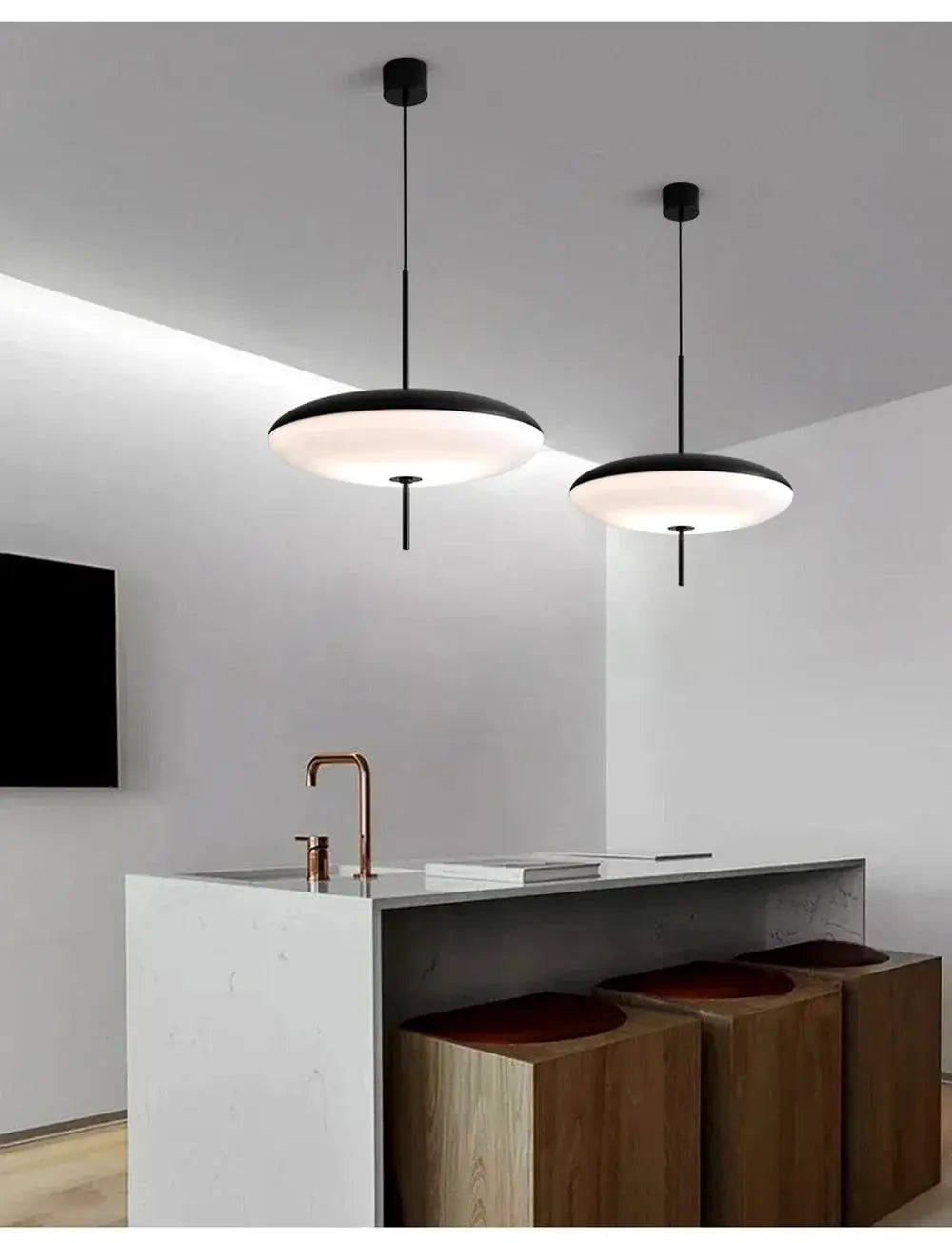 Nordic LED pendant lights in flying saucer design, white diffusers with black rims, two over a modern kitchen island.